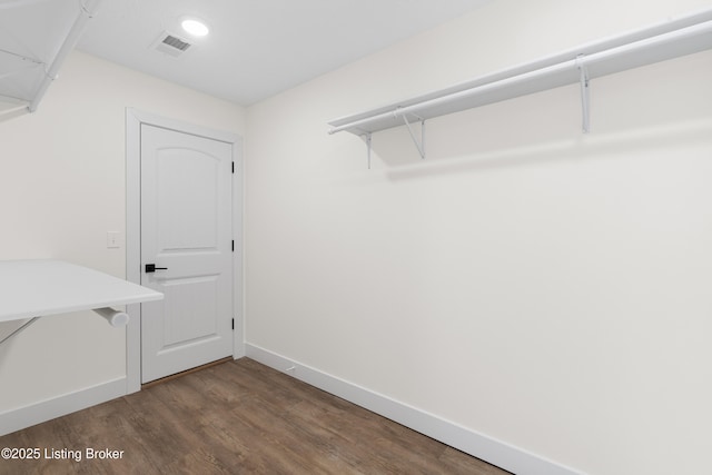 walk in closet with visible vents and wood finished floors