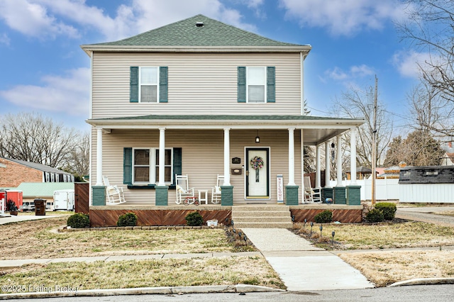 view of front of home featuring a porch, roof with shingles, and fence