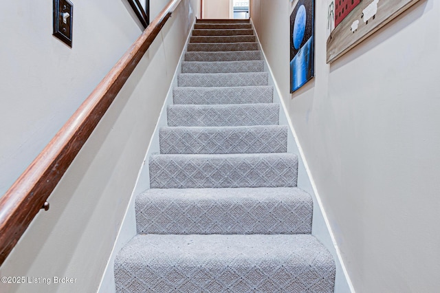 stairway featuring baseboards