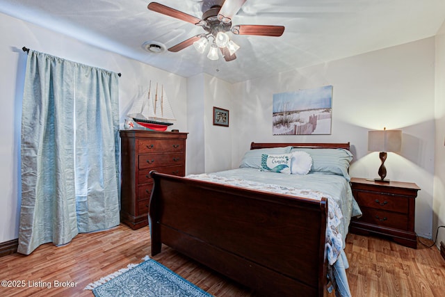 bedroom with a ceiling fan and wood finished floors