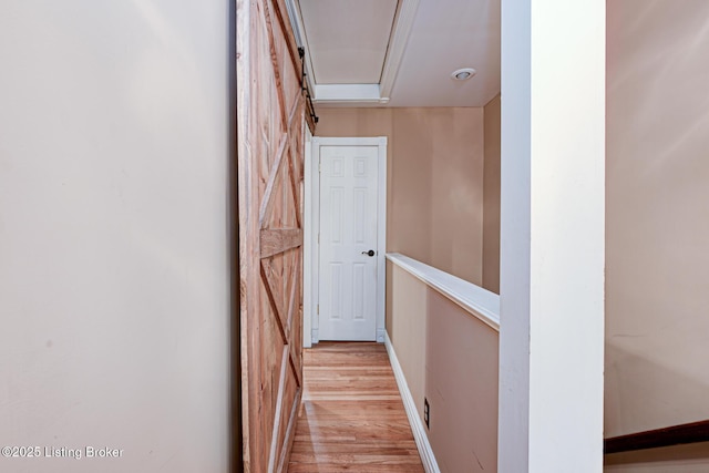 hall featuring light wood finished floors and baseboards