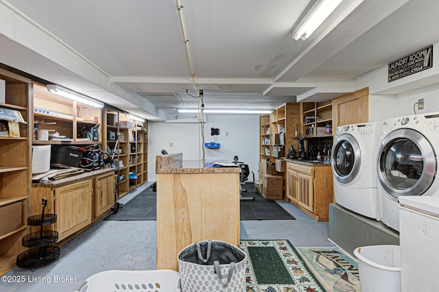 washroom with cabinet space and washer and dryer