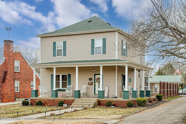 view of front of property with covered porch, central AC, and roof with shingles