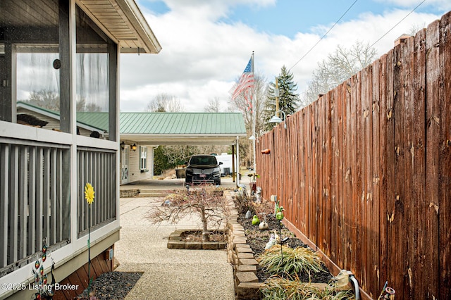 view of yard featuring a carport and fence