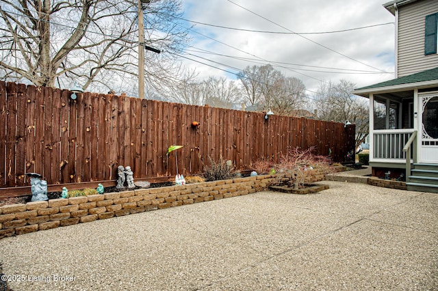 view of patio featuring a sunroom and a fenced backyard