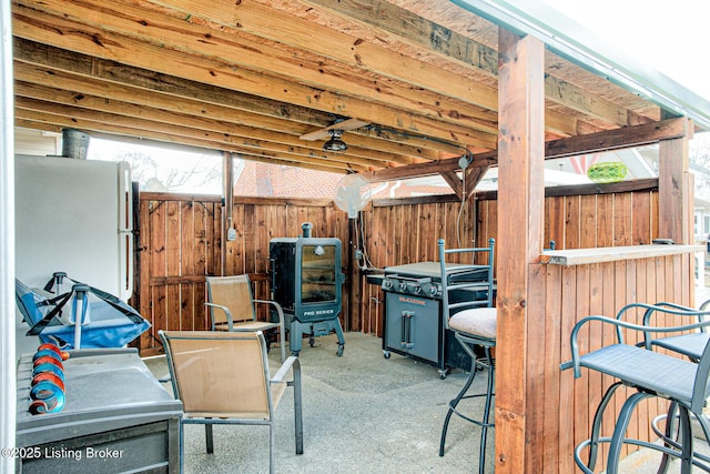 view of patio featuring fence