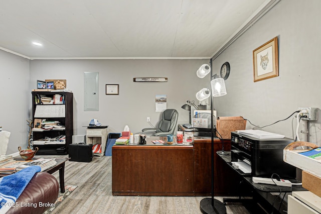 office with ornamental molding, electric panel, and light wood finished floors