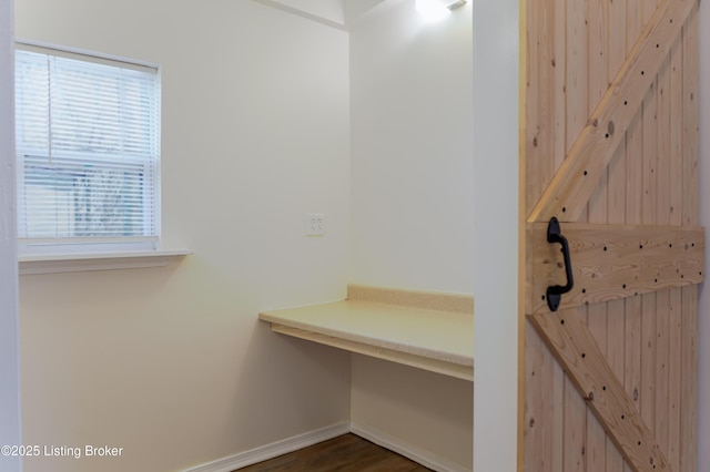 interior space featuring wood finished floors and baseboards