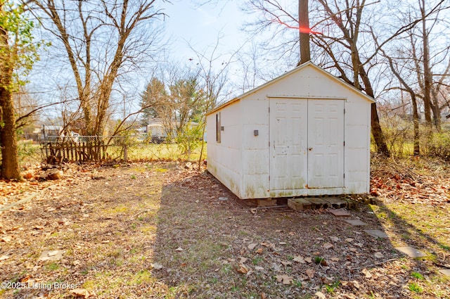 view of shed featuring fence