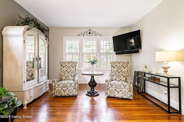 sitting room featuring a wealth of natural light and hardwood / wood-style flooring