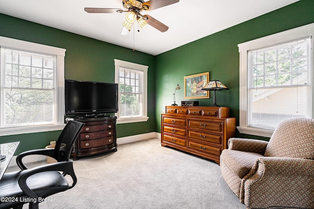 carpeted office featuring ceiling fan and baseboards