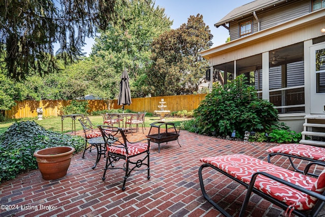 view of patio with ceiling fan and fence