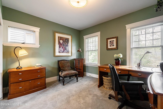 office space with baseboards and light colored carpet