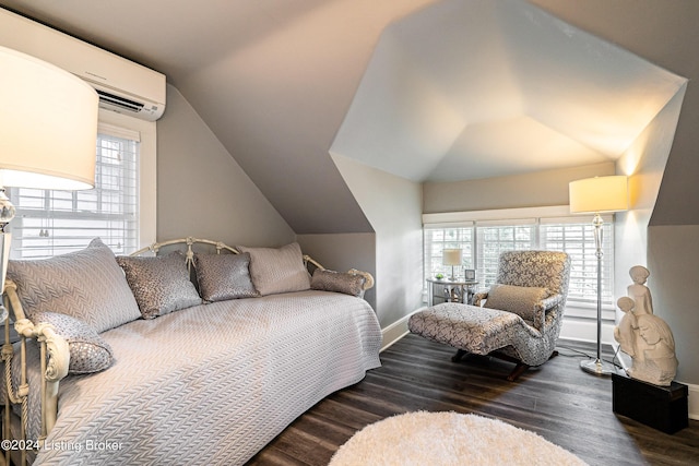 bedroom with lofted ceiling, an AC wall unit, multiple windows, and wood finished floors