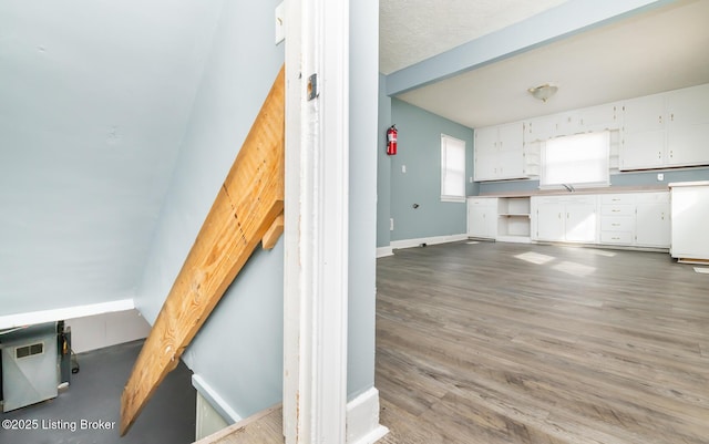 interior space featuring a sink, baseboards, and wood finished floors