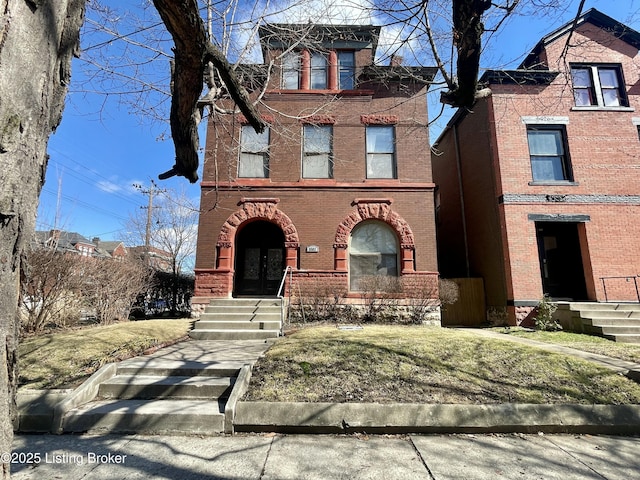 view of front facade featuring french doors and brick siding