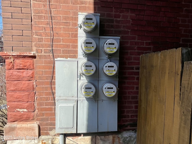 details with electric meter and brick siding