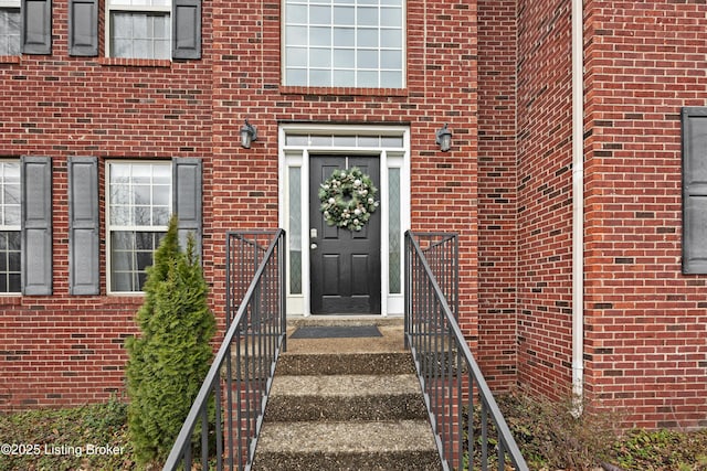 property entrance featuring brick siding