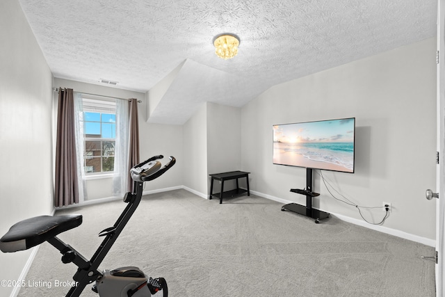 exercise room featuring baseboards, visible vents, vaulted ceiling, a textured ceiling, and carpet floors