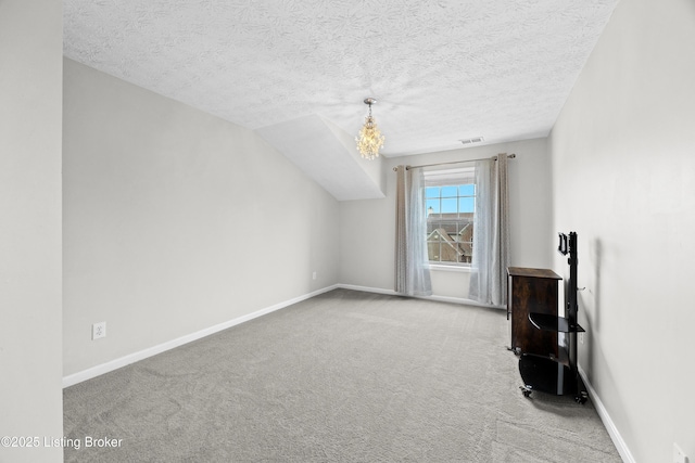 bonus room with carpet floors, baseboards, visible vents, and a textured ceiling