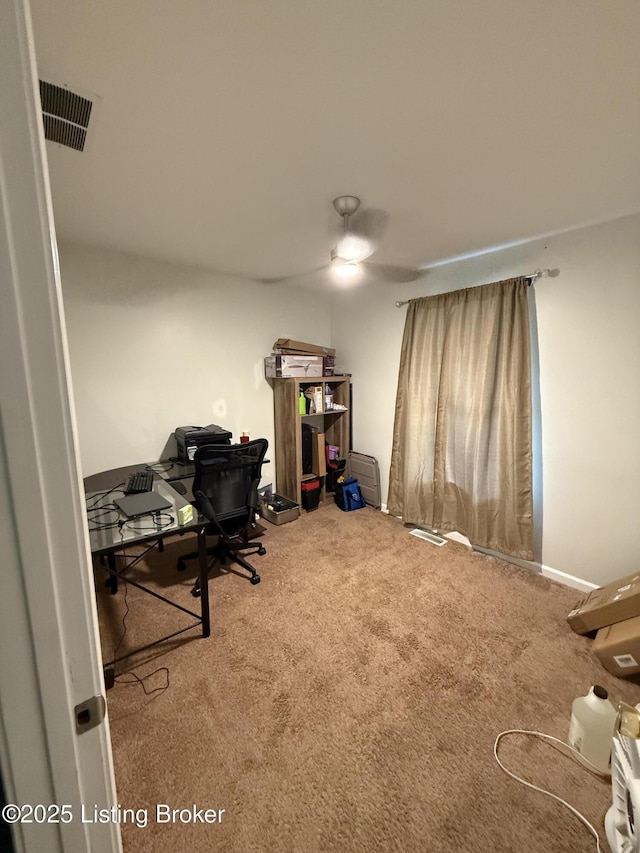 carpeted office space with baseboards and visible vents