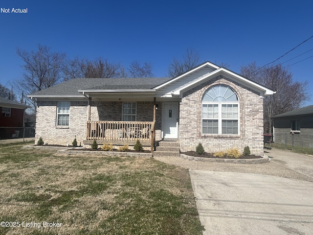 ranch-style home featuring brick siding, a front lawn, fence, and covered porch