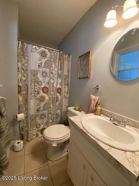 full bath with curtained shower, vanity, toilet, and tile patterned floors