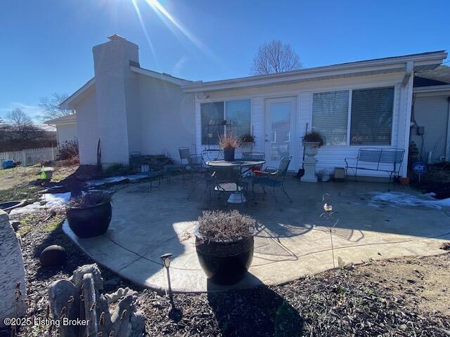 back of property with a patio area and a chimney