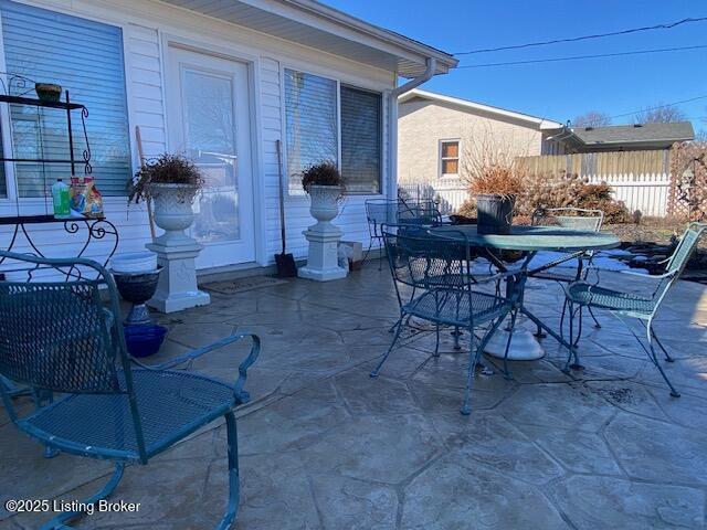 view of patio featuring fence and outdoor dining space