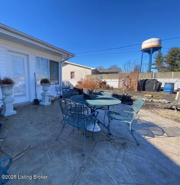 view of patio with outdoor dining area and fence