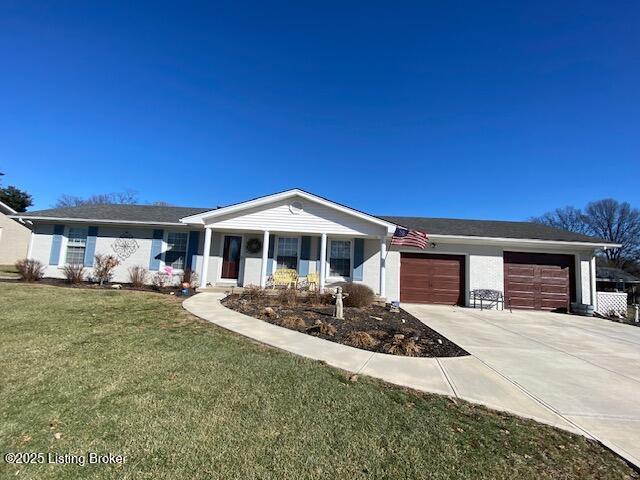 single story home featuring driveway, a front lawn, and an attached garage