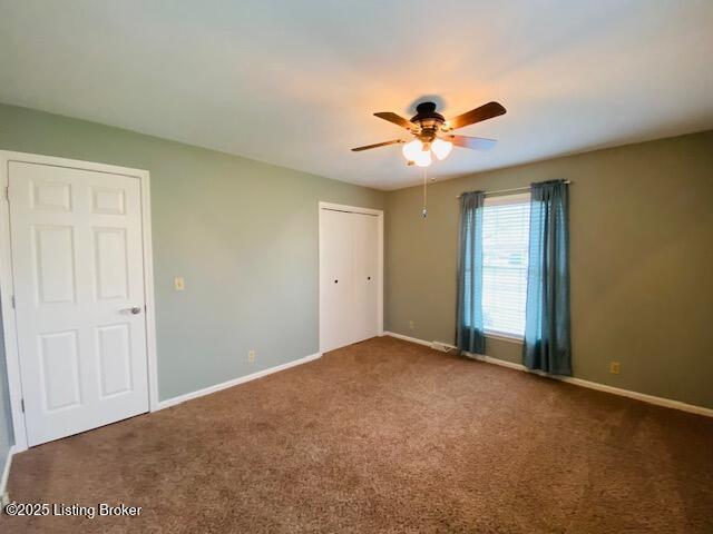 unfurnished room featuring baseboards, a ceiling fan, and carpet flooring