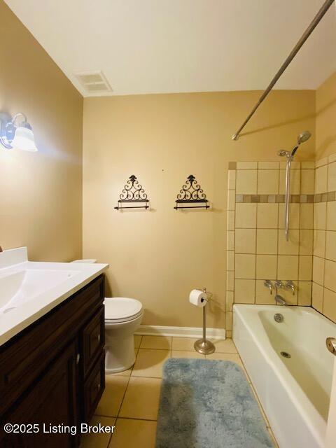 bathroom with tile patterned floors, visible vents, toilet, vanity, and tub / shower combination
