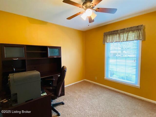 office area with carpet floors, a ceiling fan, and baseboards
