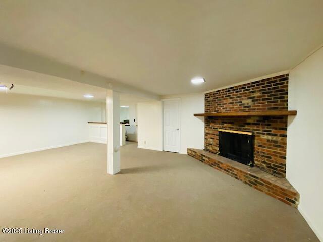finished below grade area with baseboards, recessed lighting, carpet flooring, and a fireplace