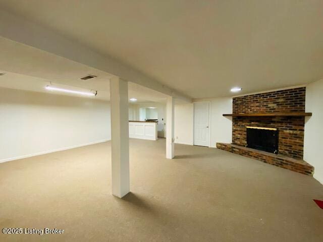 finished basement featuring a fireplace, visible vents, carpet, and recessed lighting