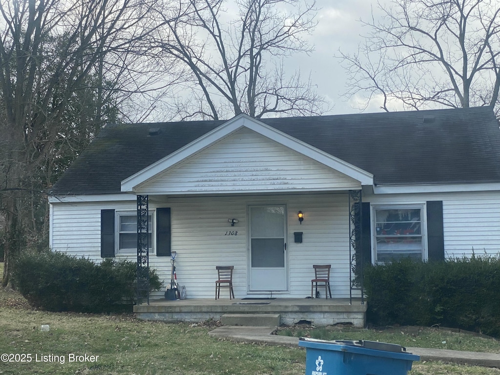 bungalow-style house featuring covered porch and a shingled roof