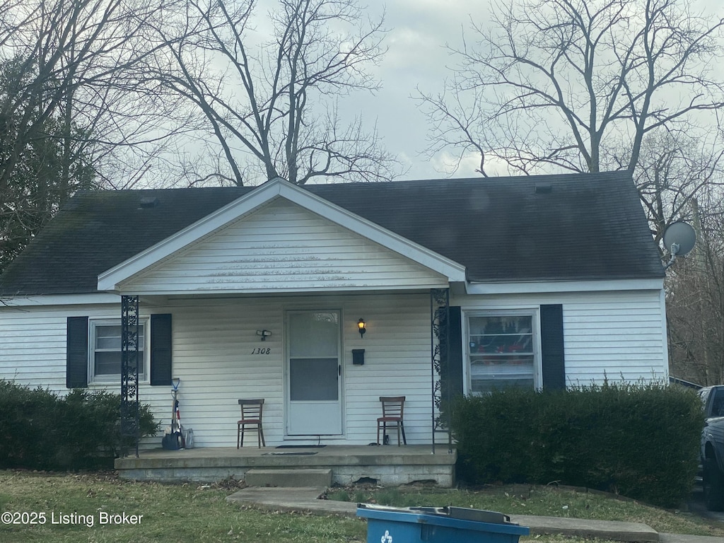 bungalow-style house featuring covered porch and roof with shingles