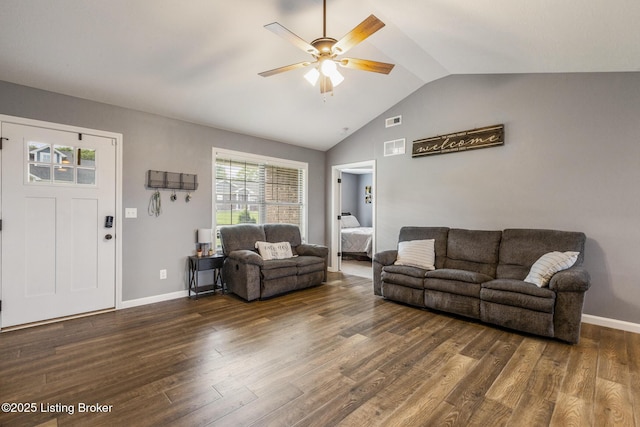 living area with visible vents, a ceiling fan, vaulted ceiling, wood finished floors, and baseboards