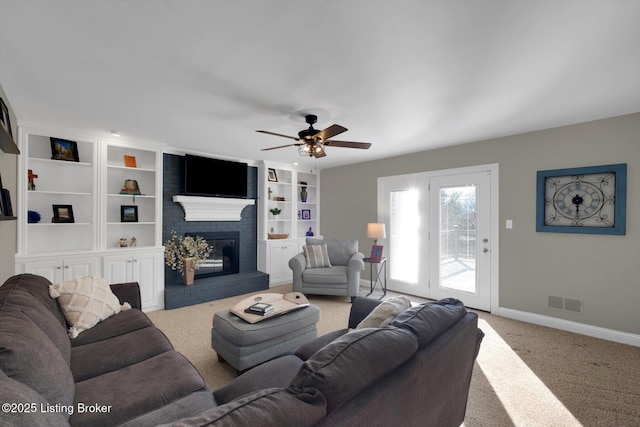 carpeted living area featuring a ceiling fan, a brick fireplace, visible vents, and baseboards