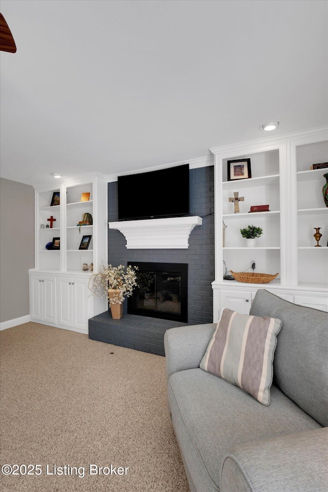 carpeted living room with built in shelves and a fireplace