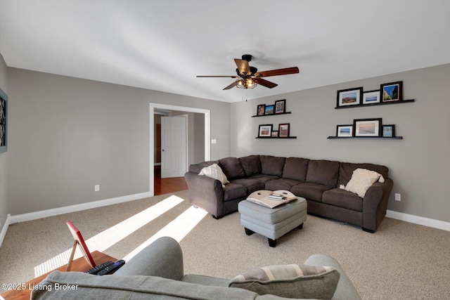 carpeted living room with ceiling fan and baseboards