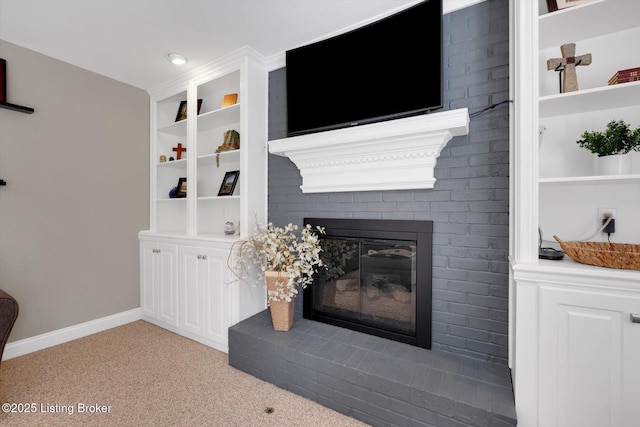 living area featuring light carpet, a brick fireplace, built in features, and baseboards