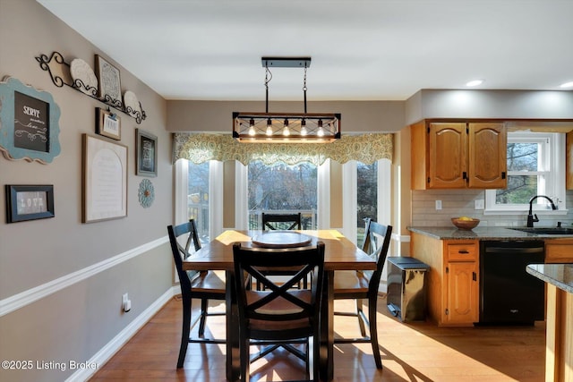 dining area with dark wood-style flooring and baseboards