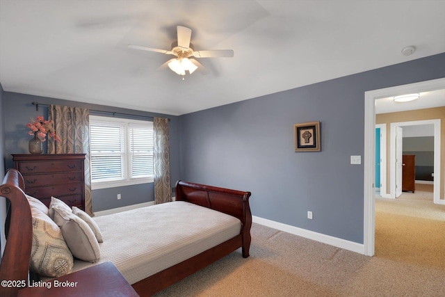 bedroom with light carpet, baseboards, and a ceiling fan