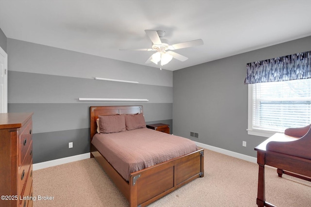 bedroom with light carpet, baseboards, visible vents, and a ceiling fan