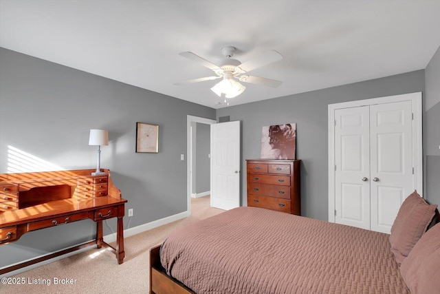 bedroom with ceiling fan, baseboards, a closet, and light colored carpet