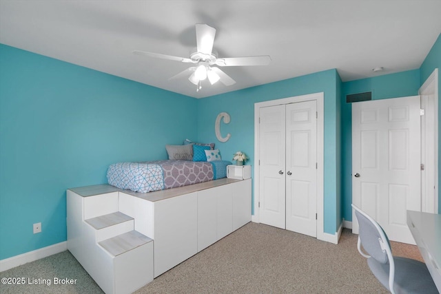 bedroom featuring carpet floors, a closet, ceiling fan, and baseboards