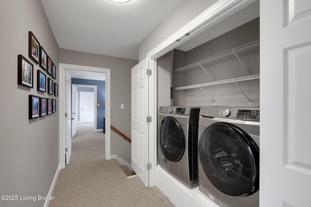 laundry area with light carpet, laundry area, baseboards, and washer and dryer