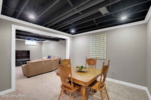 carpeted dining space with baseboards